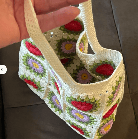 Completed floral crochet granny squares in soft spring colors
